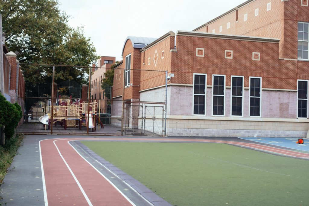 School playground with track and fenced play area.